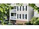 Exterior of the home with balconies, black shutters, and landscaped gardens at 923 Springfork Dr, Cary, NC 27513