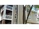 Multi-story exterior building showing neutral siding, white trim, and outdoor patios at 923 Springfork Dr, Cary, NC 27513