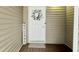 Charming front door with a decorative wreath, 'Welcome' sign and a patterned doormat at 923 Springfork Dr, Cary, NC 27513