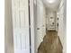 Hallway with hardwood floors, multiple storage closets, and access to the kitchen at 923 Springfork Dr, Cary, NC 27513