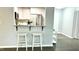 A well-lit kitchen featuring stainless steel appliances and a breakfast bar with seating at 923 Springfork Dr, Cary, NC 27513