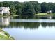 Picturesque view of the lake with houses and lush greenery in the background at 923 Springfork Dr, Cary, NC 27513