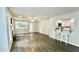 Open-concept living room with hardwood floors, fireplace, and view of the kitchen and patio at 923 Springfork Dr, Cary, NC 27513