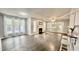 An open-concept living room featuring a cozy fireplace and ample natural light from large windows at 923 Springfork Dr, Cary, NC 27513