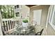 Relaxing outdoor patio featuring elegant iron chairs, a glass table and decorative plants at 923 Springfork Dr, Cary, NC 27513