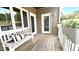 Cozy outdoor patio with a bench, decorative pillow, and potted plants at 923 Springfork Dr, Cary, NC 27513