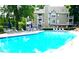 Inviting swimming pool with plenty of lounge chairs and tables for relaxation at 923 Springfork Dr, Cary, NC 27513