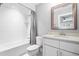 Bright bathroom featuring a tub-shower combination, white tile, and modern vanity with framed mirror at 9713 San Remo Pl, Wake Forest, NC 27587