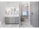 Bathroom featuring walk-in shower, modern vanity, stylish lighting, and elegant tile accents at 9713 San Remo Pl, Wake Forest, NC 27587