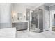 Bathroom featuring walk-in shower, soaking tub, modern vanities, and stylish lighting fixtures at 9713 San Remo Pl, Wake Forest, NC 27587