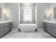 Bathroom featuring modern soaking tub, dual vanities, stylish fixtures, and elegant tile work at 9713 San Remo Pl, Wake Forest, NC 27587