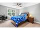 Cozy bedroom featuring a ceiling fan, a large window, and warm decor at 9713 San Remo Pl, Wake Forest, NC 27587