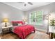 Inviting bedroom features a ceiling fan, a large window, and wood floors at 9713 San Remo Pl, Wake Forest, NC 27587