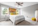 This bright bedroom features a large window, a ceiling fan, and a comfortable bed at 9713 San Remo Pl, Wake Forest, NC 27587