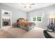 Comfortable bedroom with stylish décor, a ceiling fan, a large window, and walk in closet at 9713 San Remo Pl, Wake Forest, NC 27587