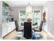 Sunlit breakfast nook featuring modern chandelier and views of the landscaped backyard at 9713 San Remo Pl, Wake Forest, NC 27587