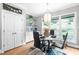 Stylish dining area features modern lighting, patterned wallpaper, and a round table with seating for four at 9713 San Remo Pl, Wake Forest, NC 27587