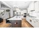 Gourmet kitchen with stainless appliances, granite countertops, bar stool seating, and access to living spaces at 9713 San Remo Pl, Wake Forest, NC 27587
