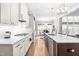 Bright kitchen featuring stainless steel appliances, a gas range, and white cabinets with marble countertops at 9713 San Remo Pl, Wake Forest, NC 27587
