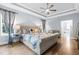 Bright main bedroom features ceiling fan, stylish furnishings, and access to a luxurious ensuite bathroom at 9713 San Remo Pl, Wake Forest, NC 27587