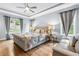 Bright main bedroom with a decorative ceiling fan, stylish furnishings, and plenty of natural light at 9713 San Remo Pl, Wake Forest, NC 27587