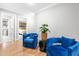 Inviting sitting area featuring hardwood floors, comfortable blue chairs, and stylish decor at 9713 San Remo Pl, Wake Forest, NC 27587