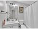 Neat bathroom featuring a single sink vanity, standard toilet, and a shower with a white curtain at 1008 Sandlin Pl # J, Raleigh, NC 27606