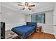 Bedroom featuring a ceiling fan and large window for natural light, and a stylish bed at 1008 Sandlin Pl # J, Raleigh, NC 27606