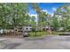 Exterior of a light blue building with brick accents surrounded by mature trees and greenery at 1008 Sandlin Pl # J, Raleigh, NC 27606
