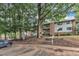 Apartment building exterior featuring mature trees and lush landscaping on a sunny day at 1008 Sandlin Pl # J, Raleigh, NC 27606