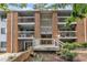 Brick apartment building featuring upper level balconies and a central stairwell at 1008 Sandlin Pl # J, Raleigh, NC 27606