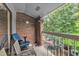 Outdoor patio area featuring a brick wall and open views of the nearby trees at 1008 Sandlin Pl # J, Raleigh, NC 27606