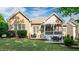 Beautifully landscaped backyard with a patio, screened porch, and lush green lawn at 101 Synandra Ln, Holly Springs, NC 27540