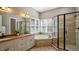 Luxurious bathroom with double vanity, soaking tub, and walk-in shower, enhanced by natural light at 101 Synandra Ln, Holly Springs, NC 27540