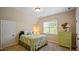 A bedroom featuring a bed with a floral comforter and natural light from the window at 101 Synandra Ln, Holly Springs, NC 27540