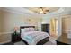 Comfortable bedroom with neutral decor, trey ceiling, ceiling fan, and ample natural light at 101 Synandra Ln, Holly Springs, NC 27540