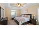 Spacious bedroom with trey ceiling, ceiling fan, and large windows with plantation shutters at 101 Synandra Ln, Holly Springs, NC 27540