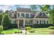 Charming two-story home featuring manicured landscaping, a welcoming porch, and classic architectural details at 101 Synandra Ln, Holly Springs, NC 27540