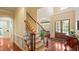 Grand foyer with hardwood floors, elegant staircase, and arched doorway at 101 Synandra Ln, Holly Springs, NC 27540