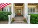 Inviting brick home entrance with double wood doors and well-manicured landscaping at 101 Synandra Ln, Holly Springs, NC 27540