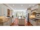 Spacious kitchen with granite countertops, center island, and hardwood flooring at 101 Synandra Ln, Holly Springs, NC 27540