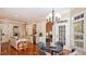 Open concept kitchen with adjacent breakfast nook featuring modern lighting and views to the exterior at 101 Synandra Ln, Holly Springs, NC 27540