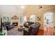 Spacious living room with a fireplace, hardwood floors, and abundant natural light at 101 Synandra Ln, Holly Springs, NC 27540