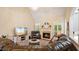 Bright living room with hardwood floors, fireplace and comfortable seating area at 101 Synandra Ln, Holly Springs, NC 27540