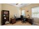 Dedicated home office space featuring built-in desk, shelves, and ample natural light for a productive work environment at 101 Synandra Ln, Holly Springs, NC 27540
