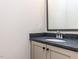 Bathroom featuring a granite countertop, updated sink and faucet, and painted cabinets at 1013 Coldspring Circle, Durham, NC 27705