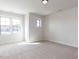 Carpeted bedroom with a light fixture and abundant natural light from the window at 1013 Coldspring Circle, Durham, NC 27705