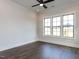Bedroom features hardwood floors, a ceiling fan, recessed lighting, and large windows at 1013 Coldspring Circle, Durham, NC 27705