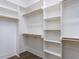 Spacious walk-in closet with custom shelving and wood rods for optimal storage at 1013 Coldspring Circle, Durham, NC 27705
