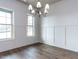 Bright dining room featuring hardwood floors, wainscoting and a modern chandelier at 1013 Coldspring Circle, Durham, NC 27705